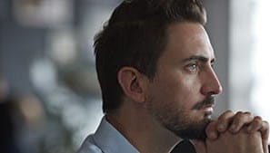 A person staring into the distance with a look of concern