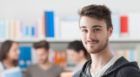 Male student in college library