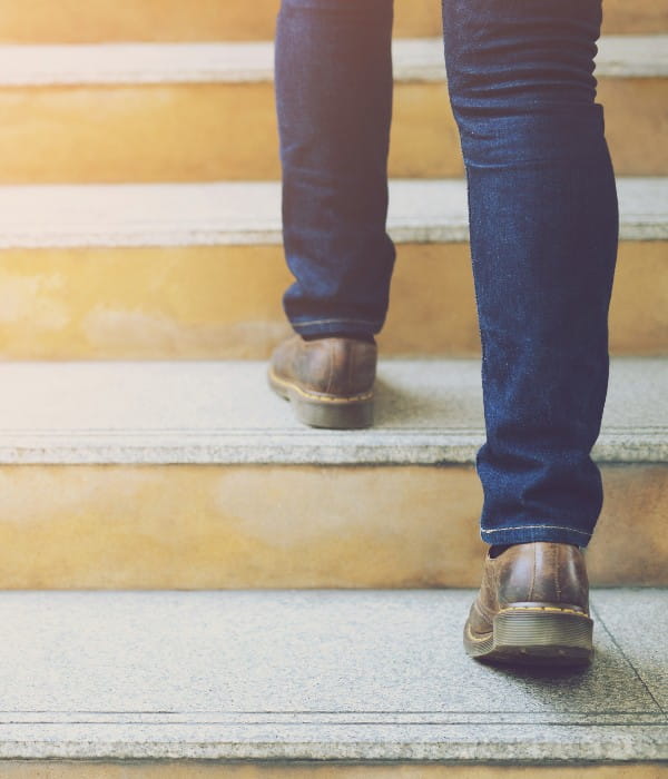 Image of a person's feet walking up steps