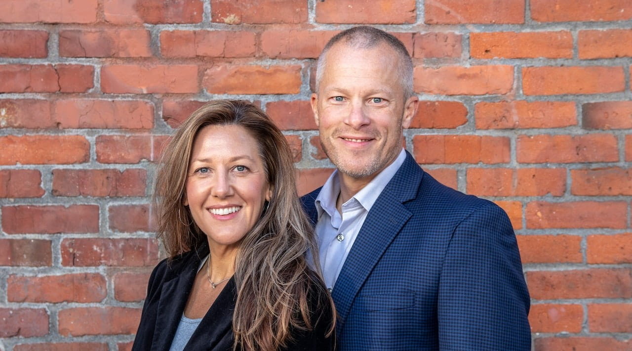 Man and woman against brick wall background