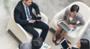 Four business people sitting in a circle having a meeting