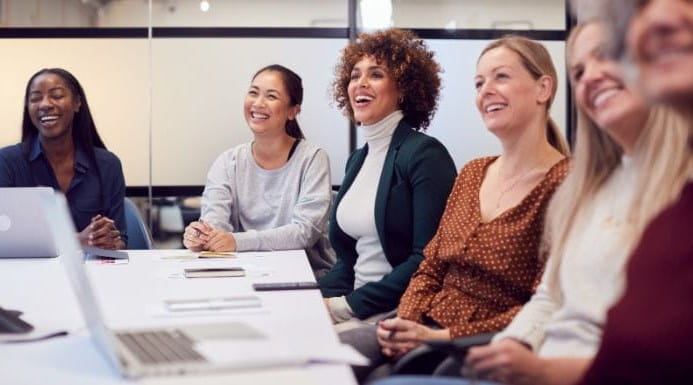 Image of people sat round a desk