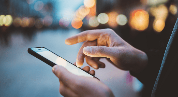 Hands using a mobile phone