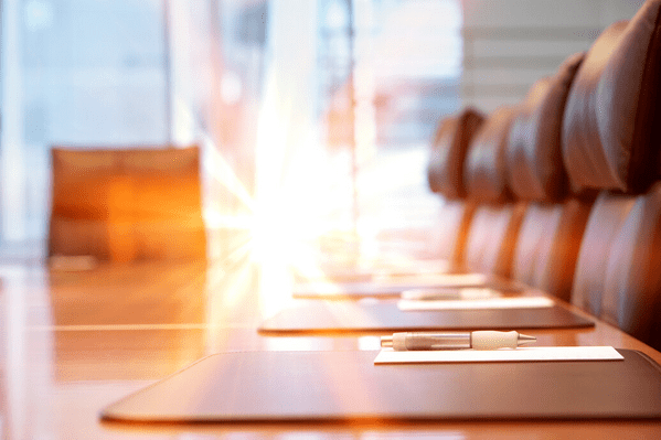 Two people standing in office boardroom