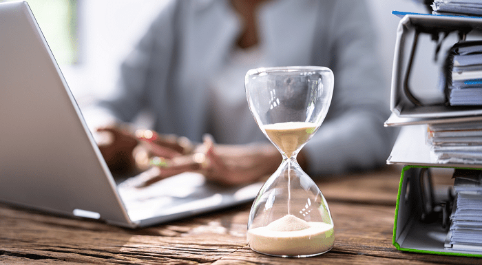 Sand timer with person working at a desk